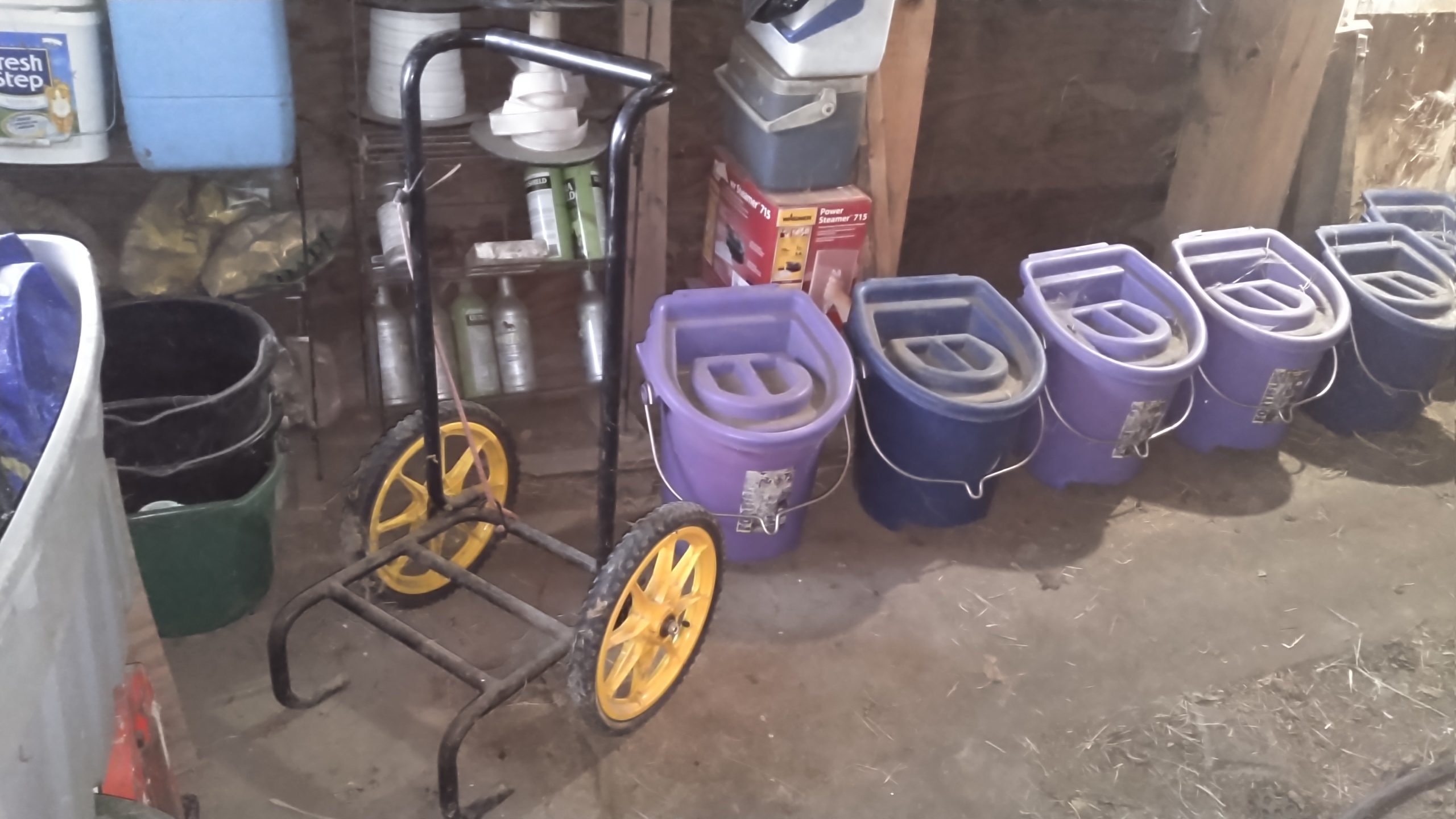 Picture of Fam and Pet Copywriter's water toting system with special 5-gal buckets with lids and a custom carrying rack.
