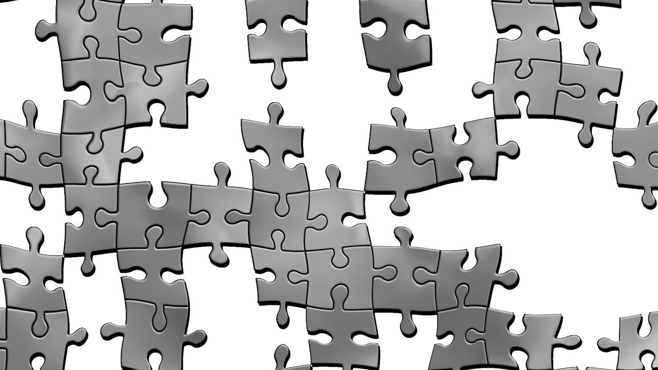 Picture of puzzle pieces, some separate and some together